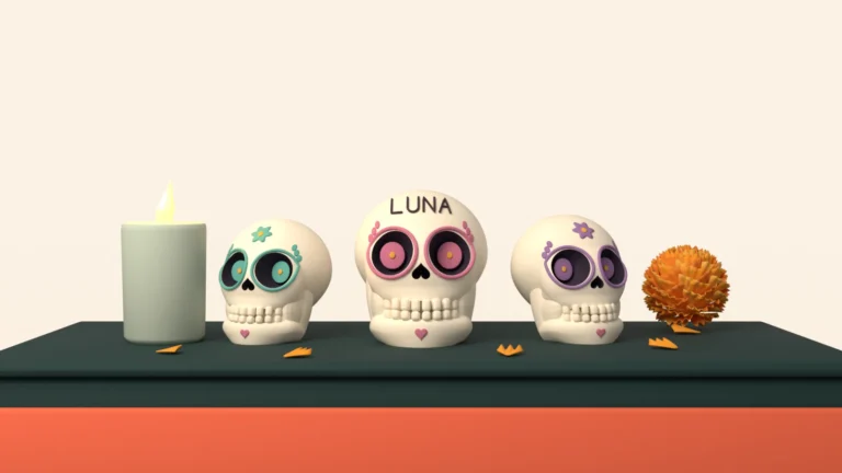 Three sugar skulls decorated with flowers on a Day of the Dead altar; the one in the middle has the name Luna on its forehead